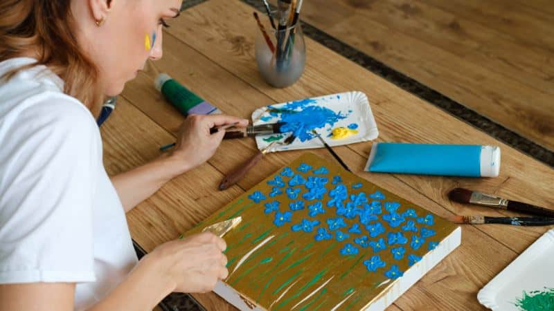 Une jeune peintre qui pratique la peinture acrylique